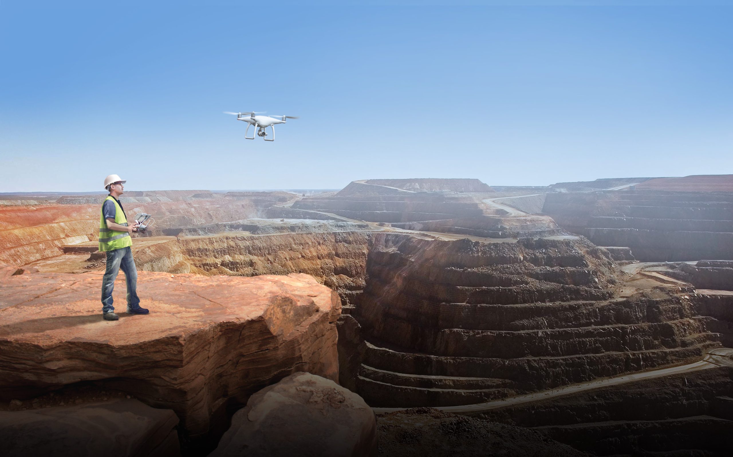 man flying drone over canyon