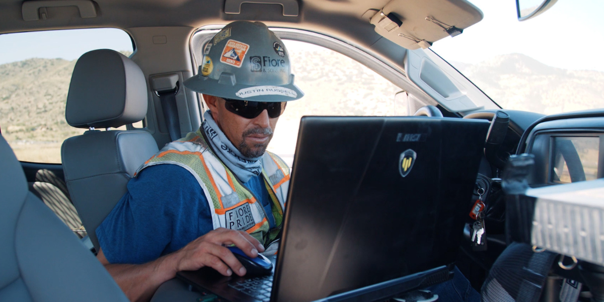 Justin from Fiore on laptop in truck