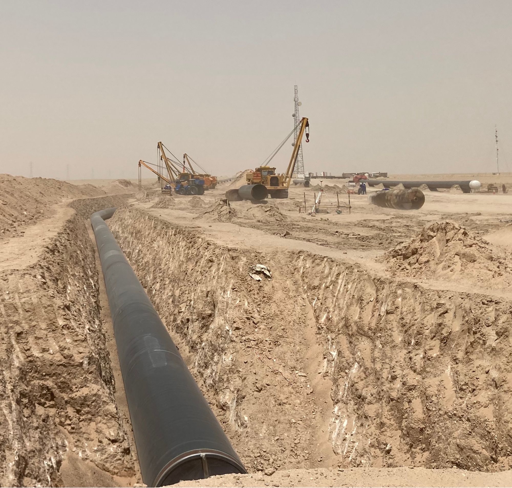 Bonatti pipeline projects, a close up of a pipe next to heavy machinery.